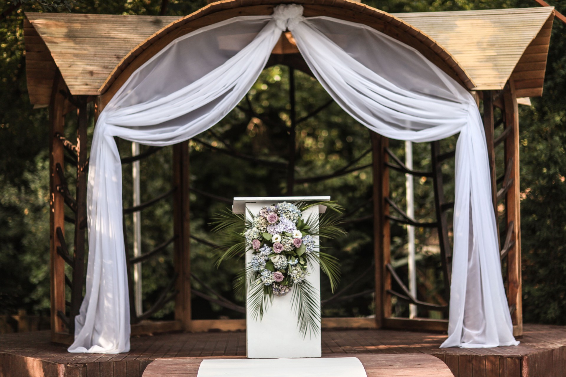 Wedding decorations in luxury ceremony. Arch for wedding ceremony a is decorated with flowers and greens, greenery.