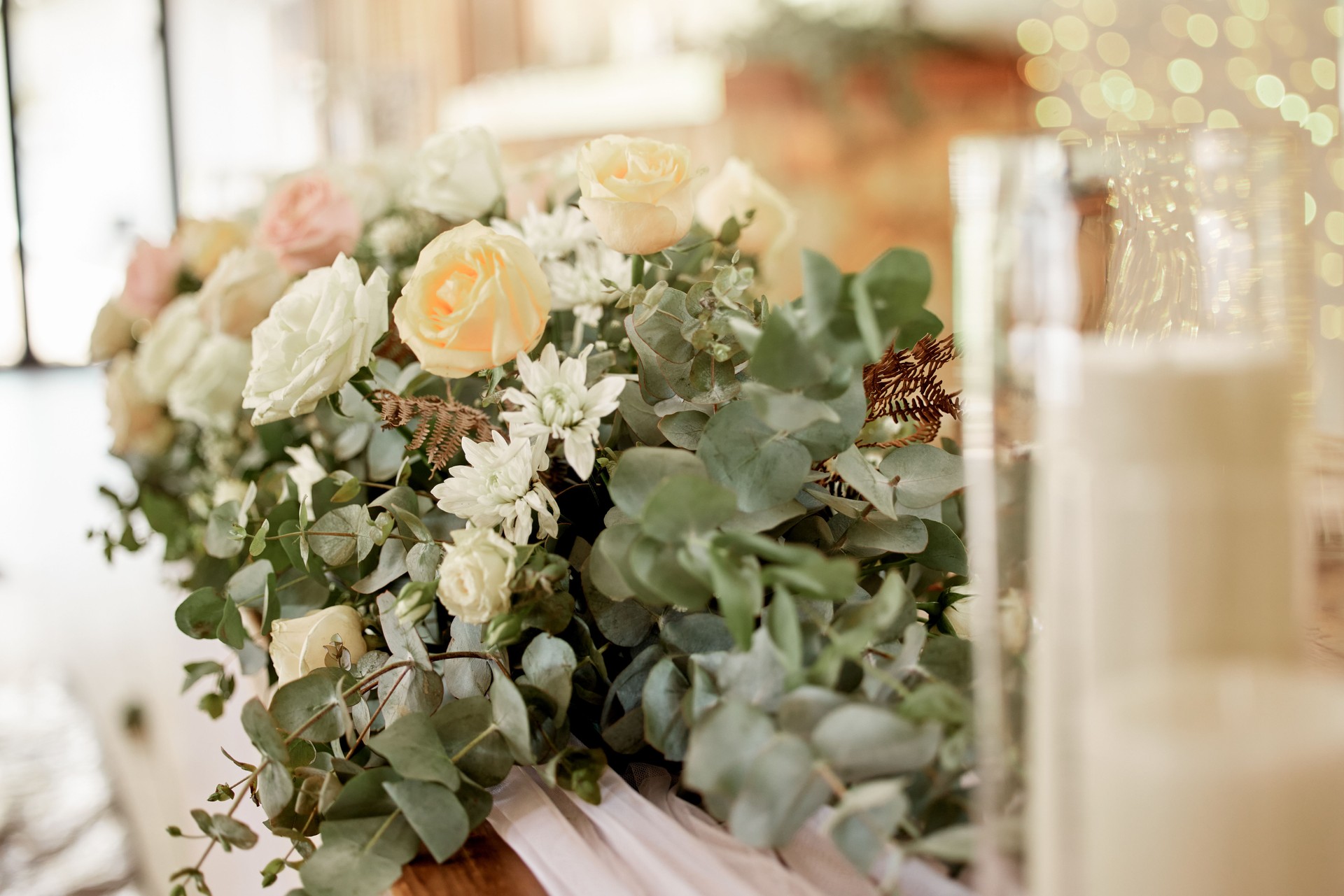 Wedding, flowers and rose on a table, decoration or gift for wedding ceremony. Luxury, event and fancy gesture with fresh bouquet at reception hall, classy bunch in celebration of marriage ceremony